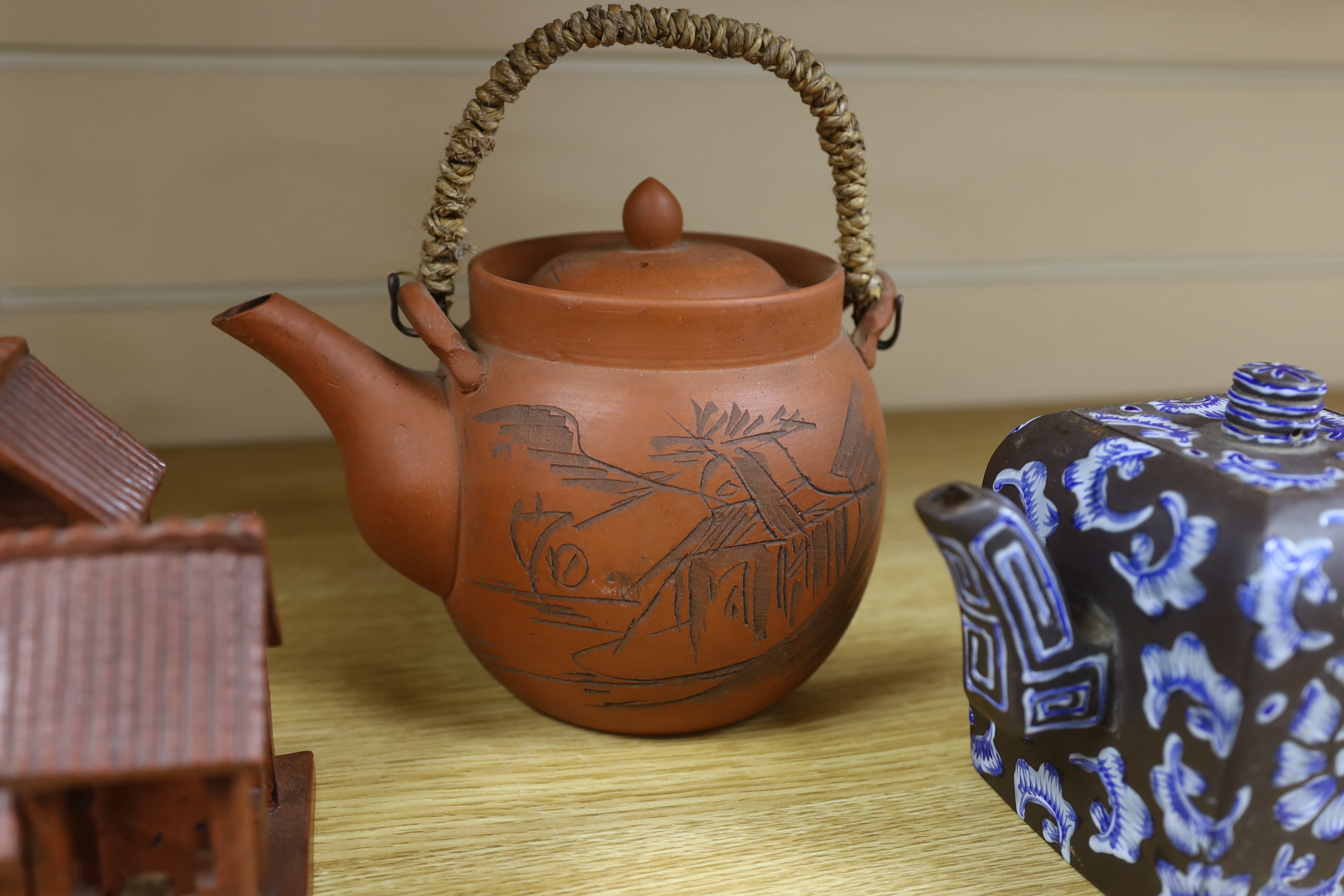A quantity of Chinese Yixing teapots and terracotta tea bowls, the largest 20cm wide